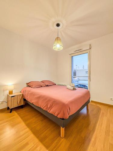 a bedroom with a large bed with a large window at Le Puilborin in Puilboreau