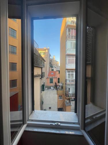 a window with a view of a city at Casa Unzaja22 in Savona