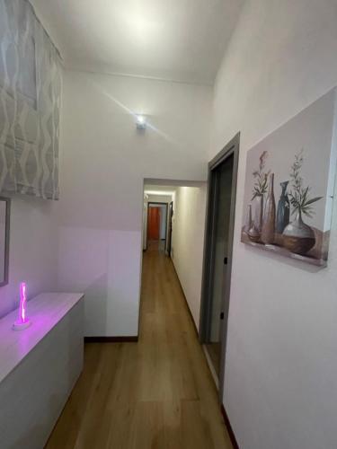 a room with a candle on a counter and a hallway at Casa Unzaja22 in Savona
