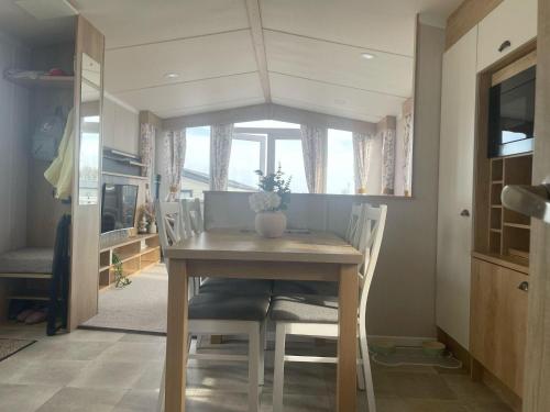 a dining room table with chairs and a window at 2 Bed-Sleeps 6-Patio-Parking-Pet Friendly in Eyemouth