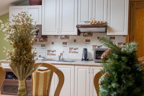 a kitchen with white cabinets and a christmas tree at Lions Heart Hostel in Lviv