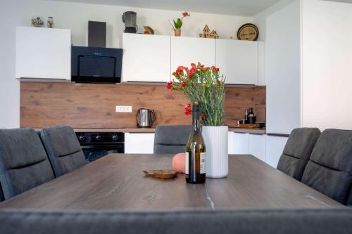 a bottle of wine on a wooden table in a kitchen at 4 Bedroom Private House On The Hill in Ljubljana