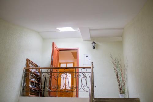 a hallway with a staircase with a orange door at Lions Heart Hostel in Lviv