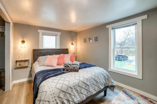 a bedroom with a bed with pink pillows and a window at 2 Mi to Saint Vincent College Home in Latrobe in Latrobe