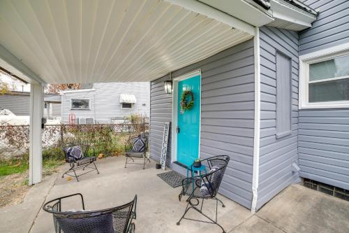 a patio with chairs and a blue door on a house at 2 Mi to Saint Vincent College Home in Latrobe in Latrobe