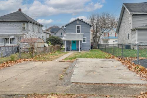 a house with a blue door in a residential neighborhood at 2 Mi to Saint Vincent College Home in Latrobe in Latrobe
