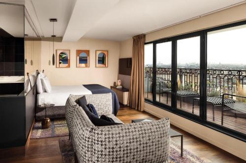 a hotel room with a bed and a balcony at Terrass" Hotel in Paris