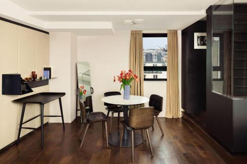 a dining room with a table and chairs at Terrass" Hotel in Paris