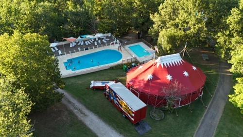 an aerial view of a house with a pool and a tent at Camping la tuque in Belaye