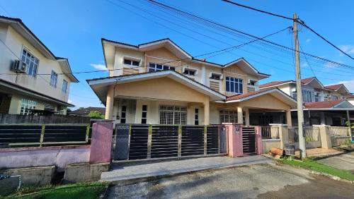 a house with a fence in front of it at Homestay ZaraMelly Kuala Terengganu in Kuala Terengganu