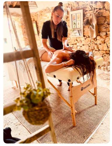 a woman sitting on a chair with her hair at Authentique bergerie en pierre avec jacuzzi piscine et massages La grange des amoureux in Le Beausset