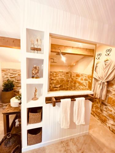 a bathroom with white towels and a mirror at Authentique bergerie en pierre avec jacuzzi piscine et massages La grange des amoureux in Le Beausset