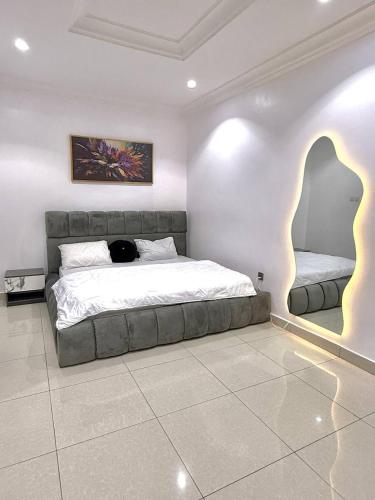 a bedroom with a large bed in a room at 1 bedroom Shortlet Apt at Osapa London Lekki in Lagos