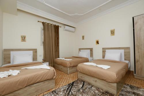 a bedroom with two beds with white towels on them at ATLAS pyramids VIEW in Cairo