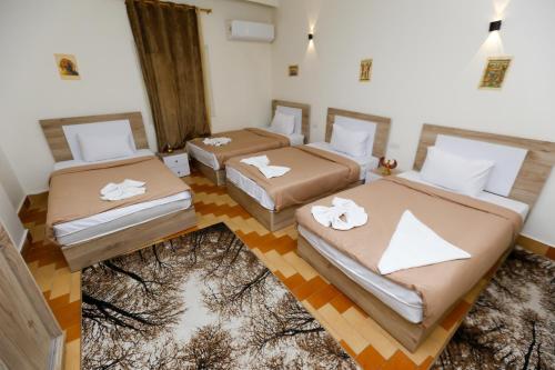a room with three beds in a room at ATLAS pyramids VIEW in Cairo