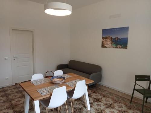 a living room with a table and a couch at Scopelos in Scopello