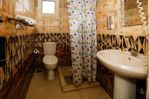a bathroom with a toilet and a sink at ATLAS pyramids VIEW in Cairo