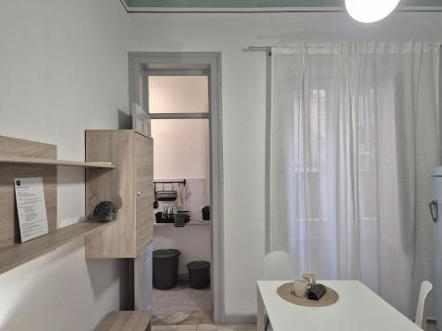 a white room with a table and a window at La Mattanza in Trapani