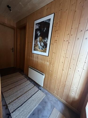 a room with a picture on a wooden wall at Chalet El Nido Nendaz in Iserables