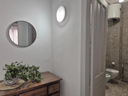 a bathroom with a mirror and a sink and a toilet at La Mattanza in Trapani