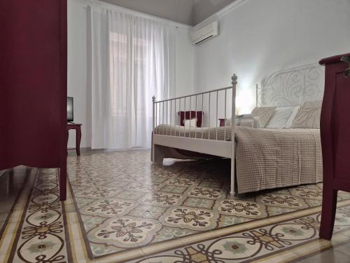 a bedroom with a bed and a rug at La Mattanza in Trapani