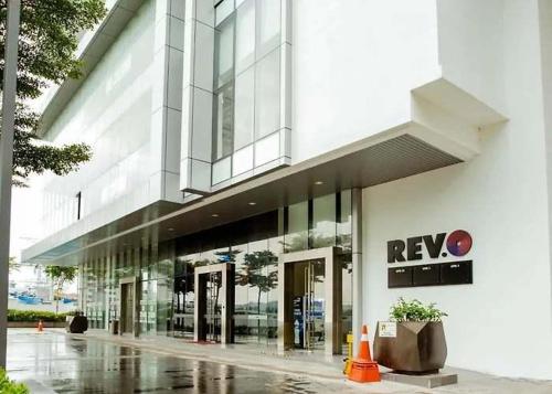 a large building with a new logo on it at Revo Aurora Home at Pavilion Bukit Jalil in Kuala Lumpur