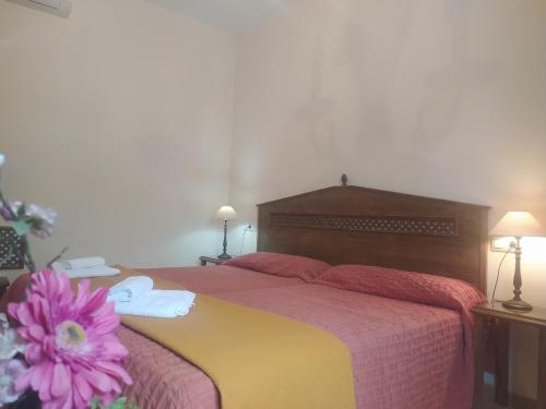 a bedroom with a large bed with a pink flower on it at Jayca in Trujillo