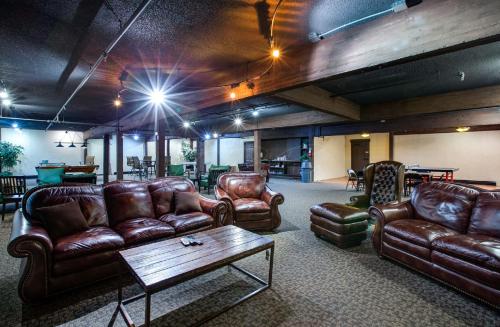 a living room with leather couches and a table at Snowline Lodge - Condo 37 - A very cute condo - near the mountain, now has Wifi in Deming
