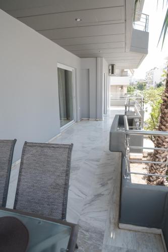a room with chairs and a sink in a building at Sea View Apartment in Chalkida