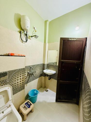 a small bathroom with a sink and a toilet at Hotel Vrinda Maheshwar in Maheshwar