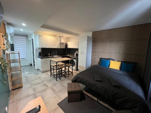 ein Schlafzimmer mit großem Bett und eine Küche in der Unterkunft Studio confortable avec balcon in Villeneuve-sur-Lot