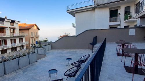 a balcony with chairs and tables on a building at Terrazza 72 - Deluxe Room & Breakfast in Agerola