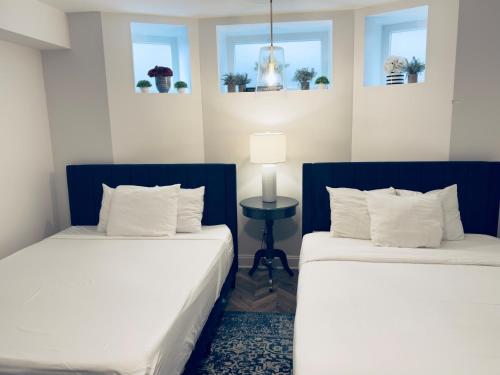 two beds sitting next to each other in a room at The Washington Downtown Boutique Hotel in Sandusky