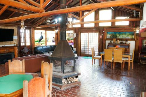 a large living room with a stove in the middle at Hotel Fazenda Poços de Caldas in Poços de Caldas