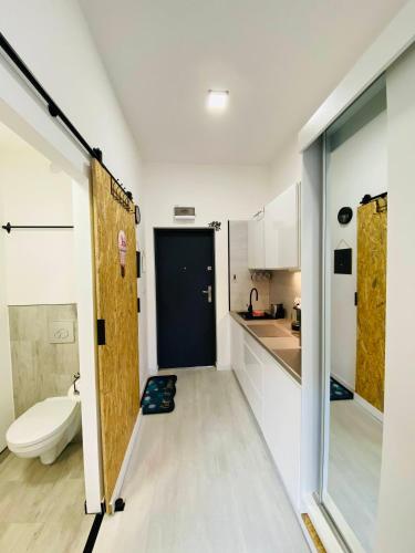 a bathroom with a door and a toilet in a room at 36-Maniana - DeerRest Apart in Jelenia Góra