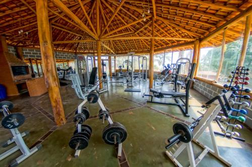 a gym with several treadmills and machines at Hotel Fazenda Poços de Caldas in Poços de Caldas