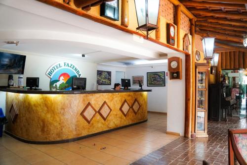 a restaurant with a counter in the middle of a room at Hotel Fazenda Poços de Caldas in Poços de Caldas
