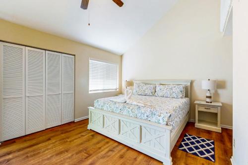 a white bedroom with a bed and a window at Brandywine South 4G in Myrtle Beach