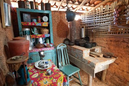 a kitchen with a table and a chair in a room at Hotel Fazenda Poços de Caldas in Poços de Caldas