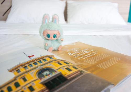 a toy rabbit is sitting on top of a book at Lumina Home in Ho Chi Minh City