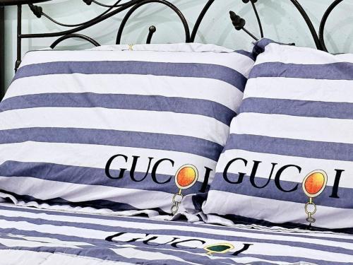 a bed with blue and white pillows on it at Extra Big Unit with Paddy Field View and 5 mins to Sekinchan attractions in Sekincan