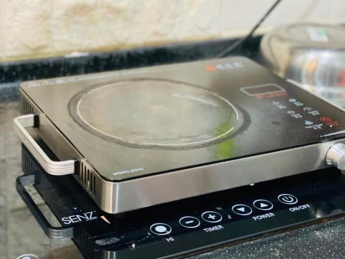 a toaster oven with a plate on top of it at Extra Big Unit with Paddy Field View and 5 mins to Sekinchan attractions in Sekincan
