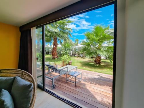a room with a sliding glass door with a view of a deck at Hommage Hotel & Residences in Baie Nettle
