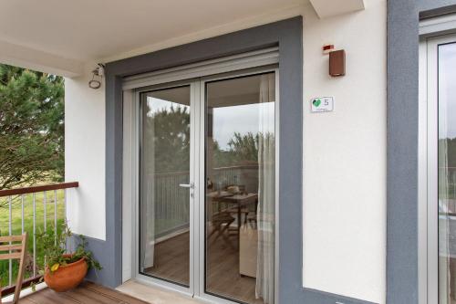 a sliding glass door on a house with a patio at Quinta dos Raposos- Nazaré Portugal in Nazaré