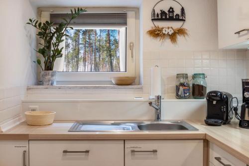 a kitchen with a sink and a window at Ferienwohnung Im Kleinen Feld in Waldeck
