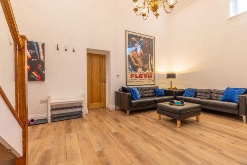 a living room with a couch and a table at Swafield Hall in Swafield