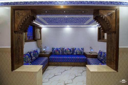 a room with a blue couch in a room at Casa Sanae in Chefchaouene