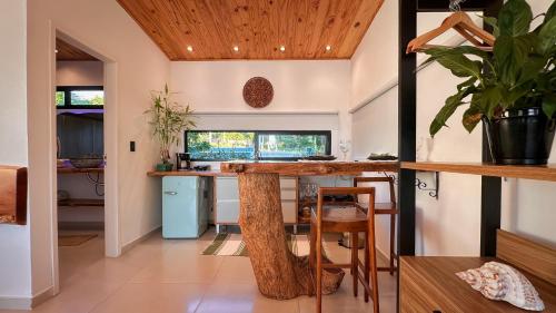 a kitchen with a large tree stump table in a house at Pipa Sunset Villa in Pipa