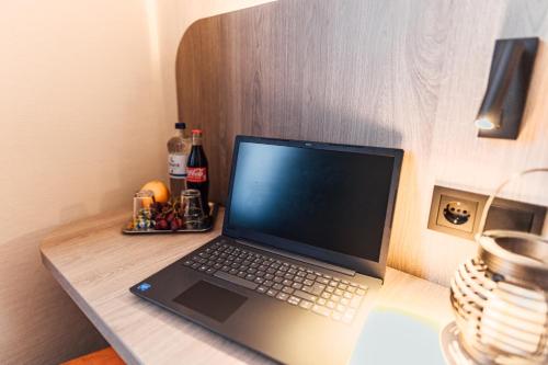 a laptop computer sitting on top of a desk at Hotel Commerz Hamburg in Hamburg
