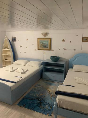 a bedroom with two beds and a dresser in it at La Doi Pasi De Mare in Vama Veche